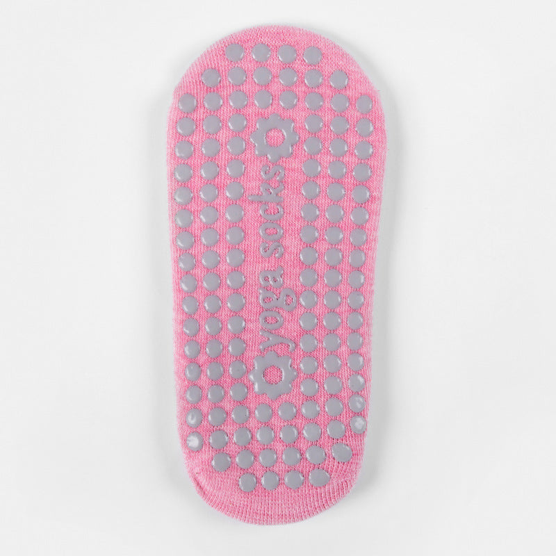 Sole of a pink grip sock with raised grip dots