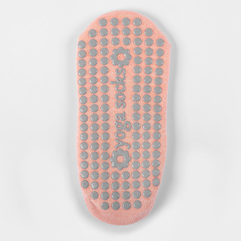 Sole of an orange grip sock with raised grip dots