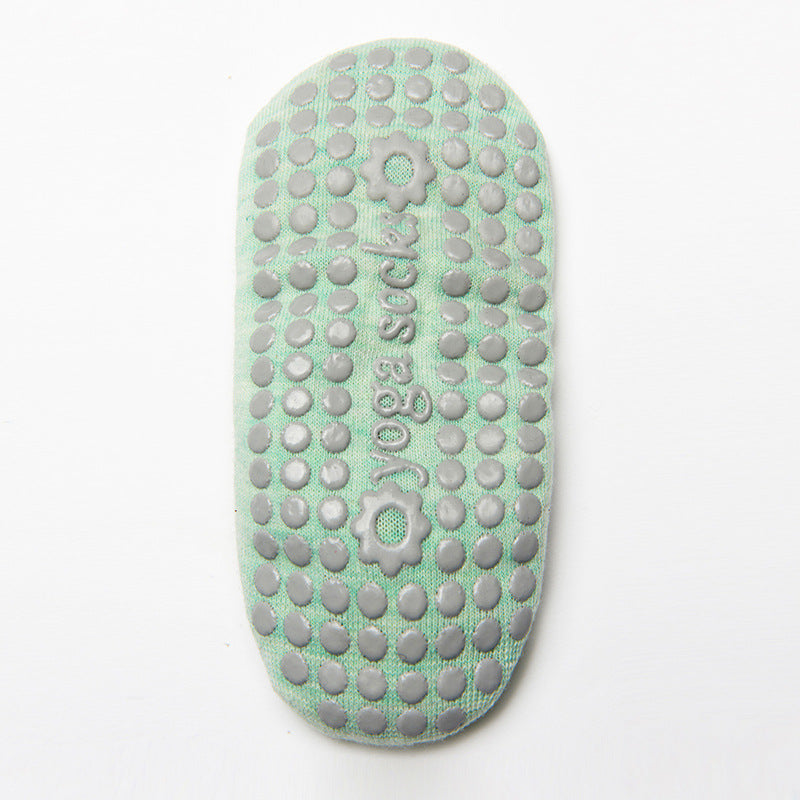 Sole of a green grip sock with raised grip dots