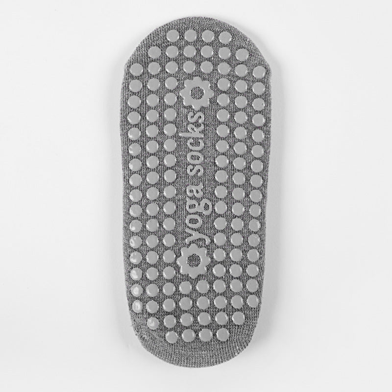 Sole of a grey grip sock with raised grip dots